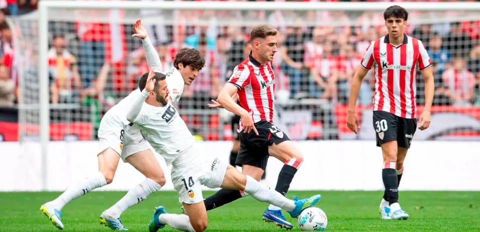 Athletic Club player tackling Valencia opponent