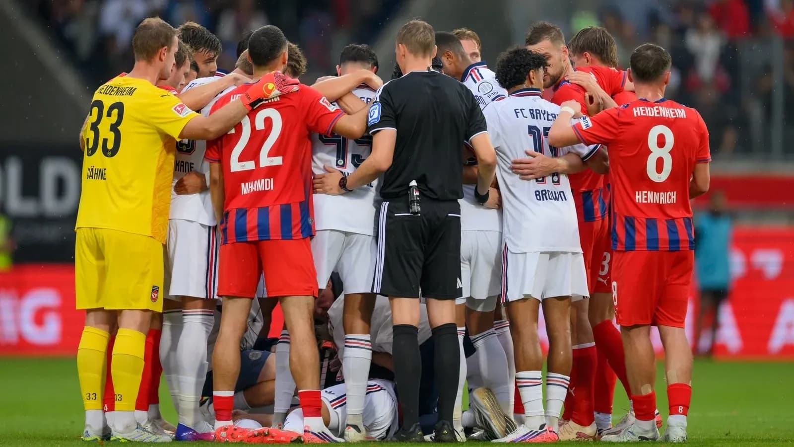 Players from both teams huddled during a stoppage