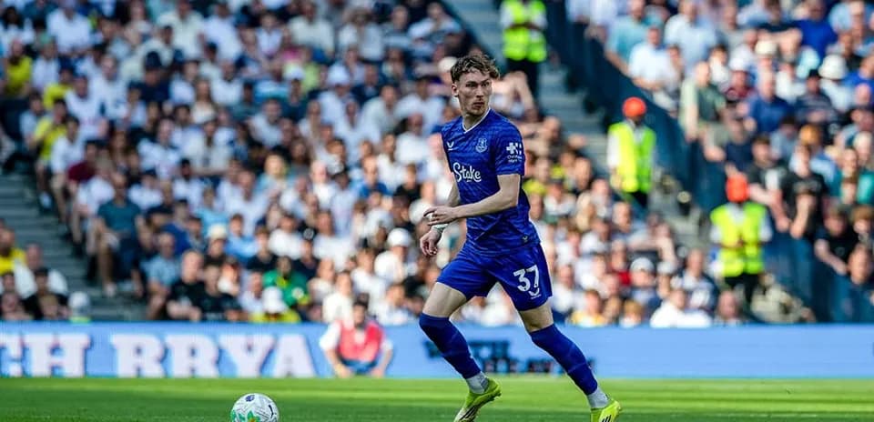 Player in blue kit dribbling on the field