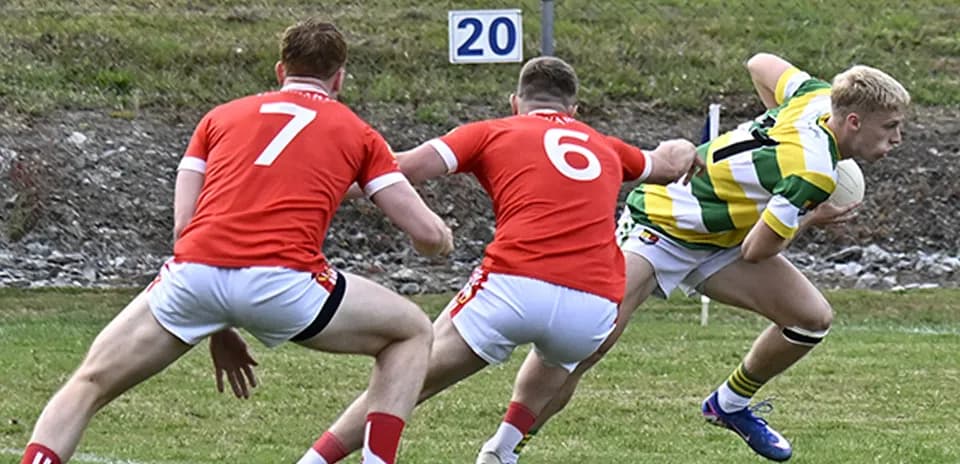 Player evading two defenders during a rugby match