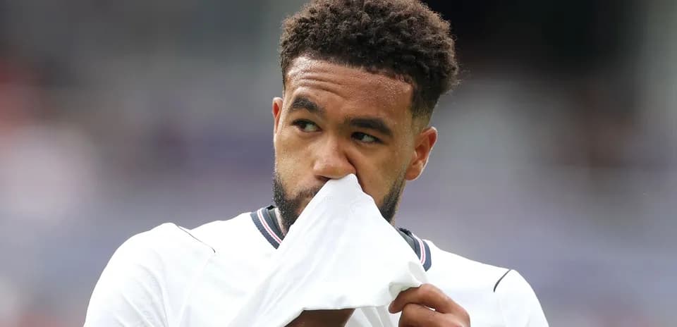 Player holding jersey close to face during match