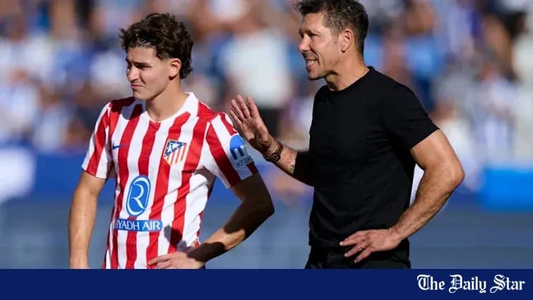 Atletico Madrid coach instructing player on field