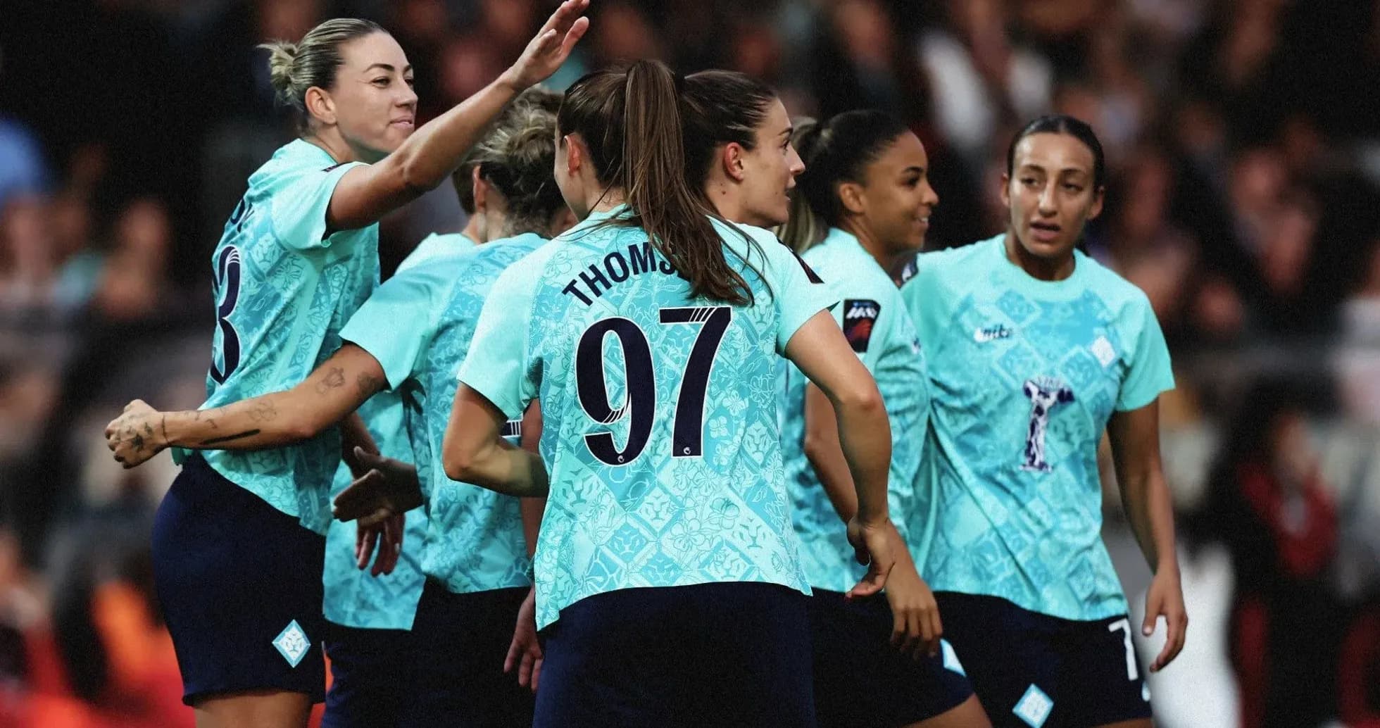 Players celebrating a goal during a match