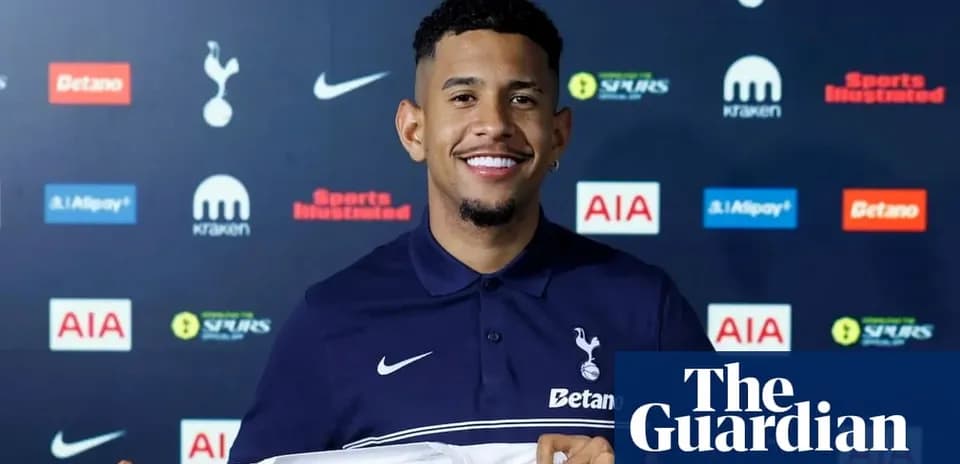 Player holding Tottenham Hotspur jersey at unveiling