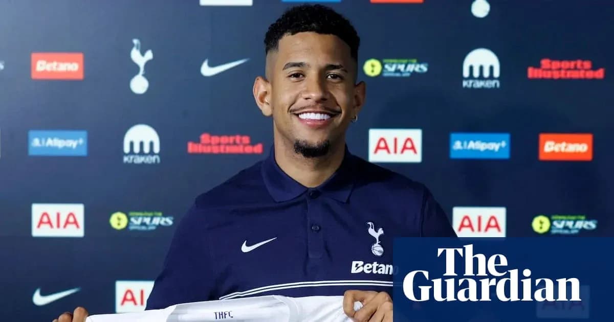 Player holding Tottenham Hotspur jersey at unveiling