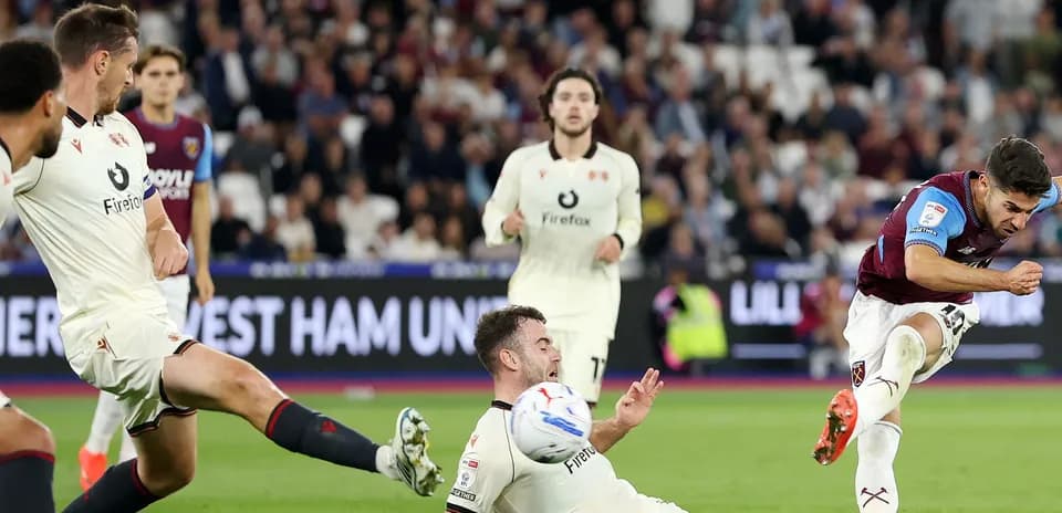 West Ham player shooting at goal during match
