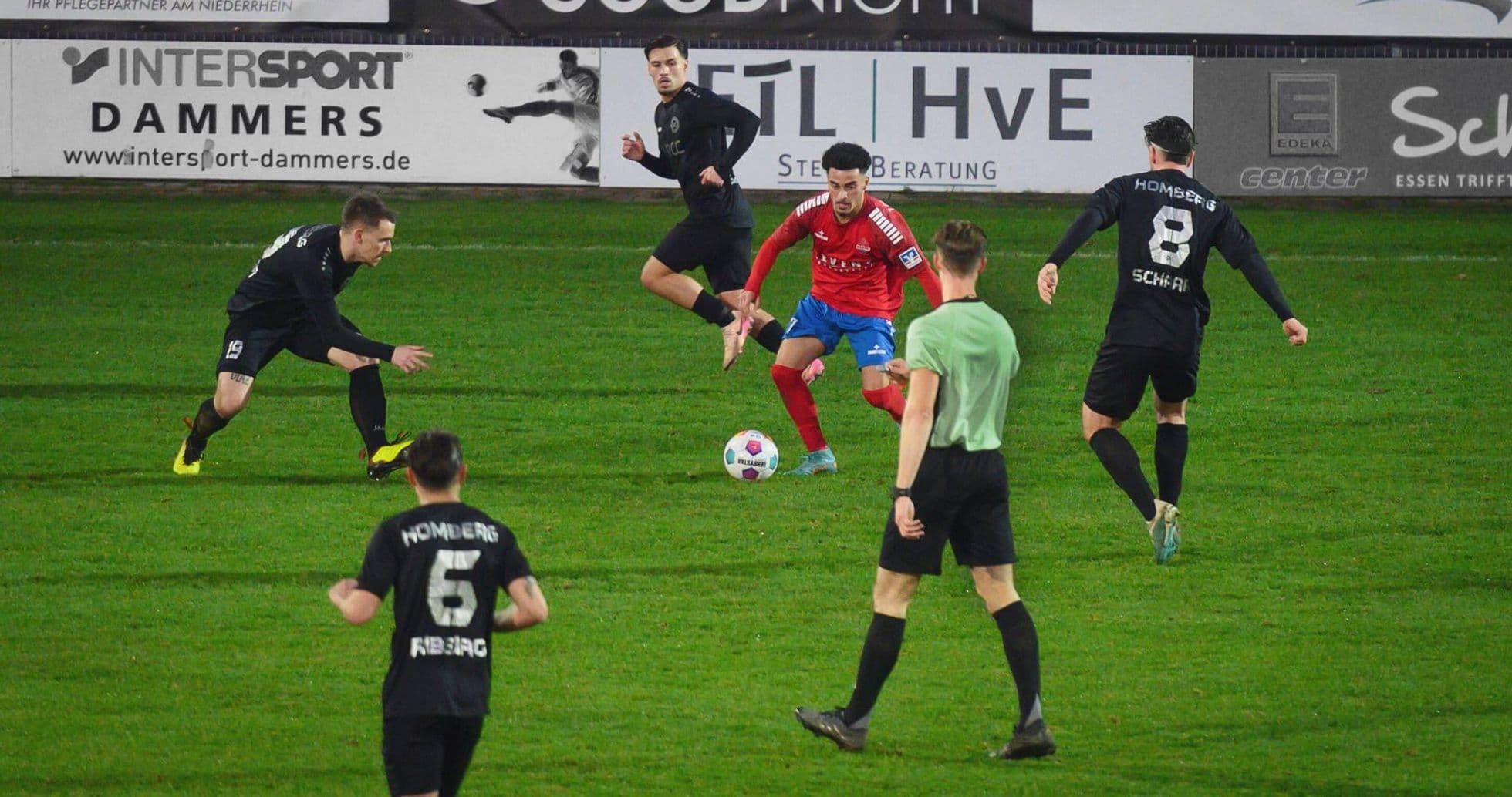 Players competing for the ball in Oberliga match