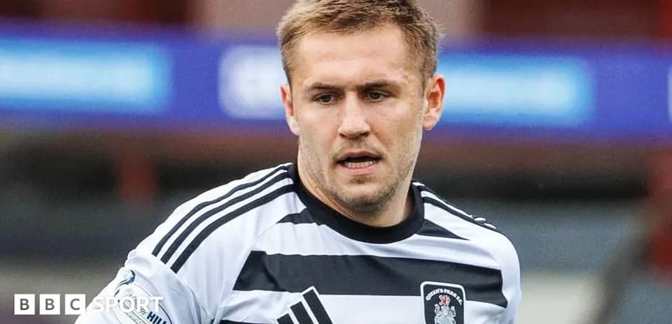 Player in black and white jersey during match