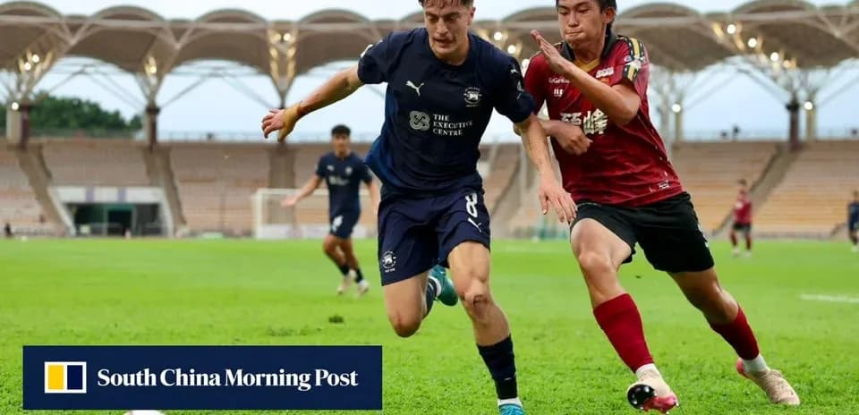 Player in blue shirt attempts to evade opponent in red