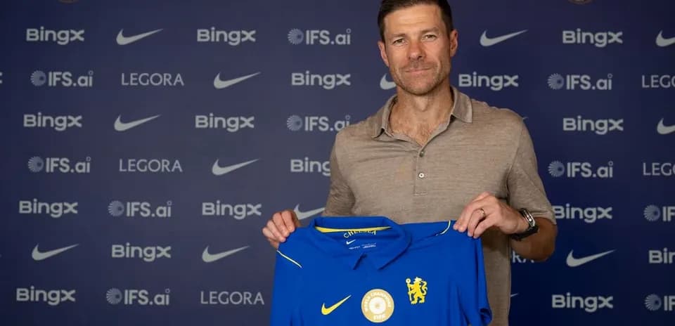 New manager holding Chelsea FC jersey at presentation