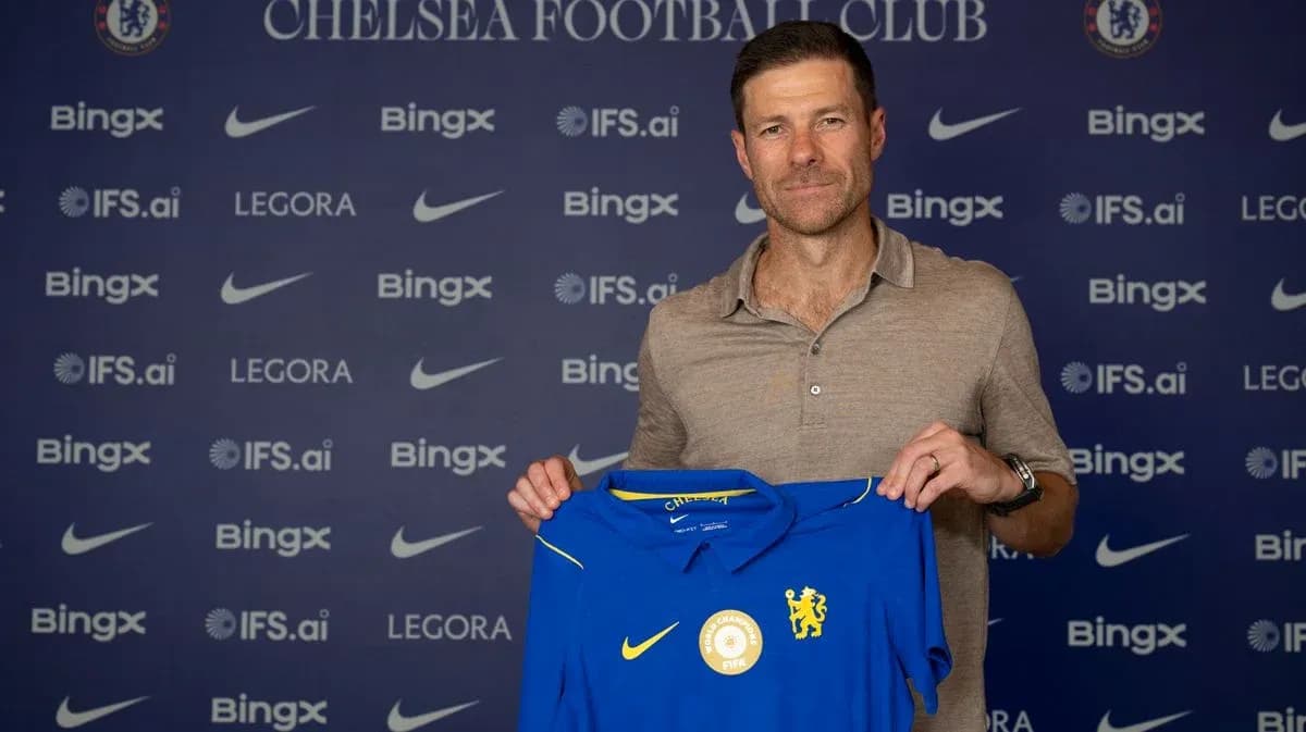 New manager holding Chelsea FC jersey at presentation