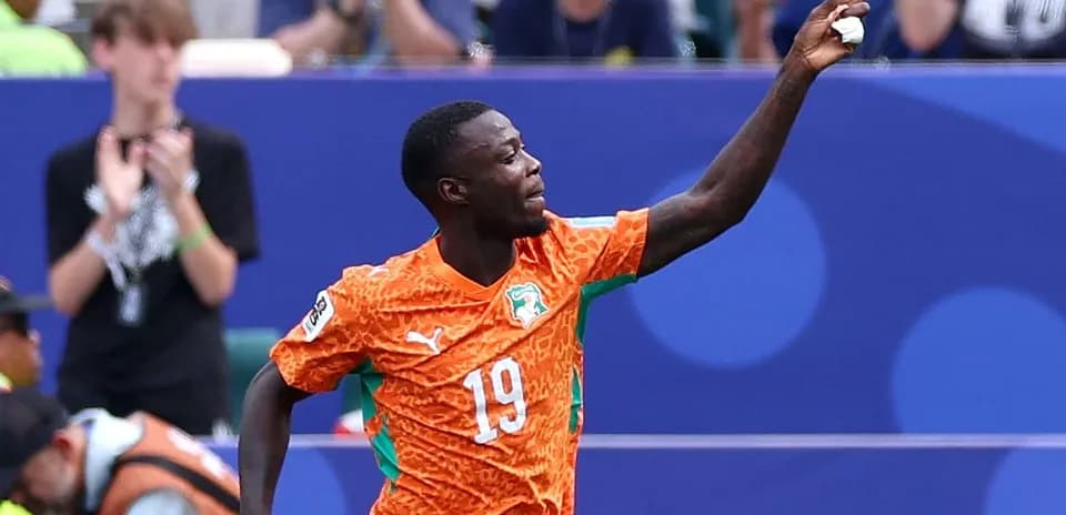 Player celebrating a goal in orange jersey