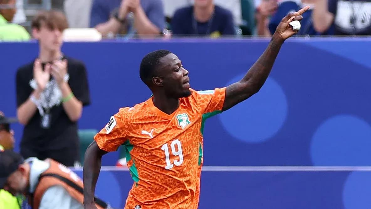 Player celebrating a goal in orange jersey