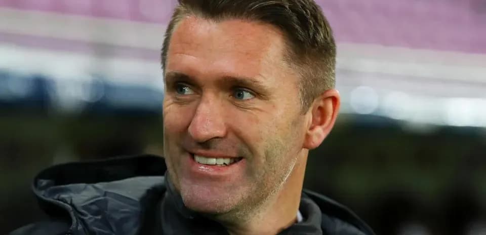 Coach smiling during match warm-up session