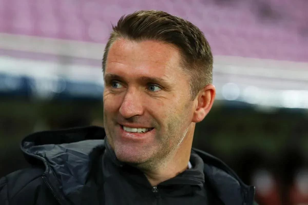 Coach smiling during match warm-up session