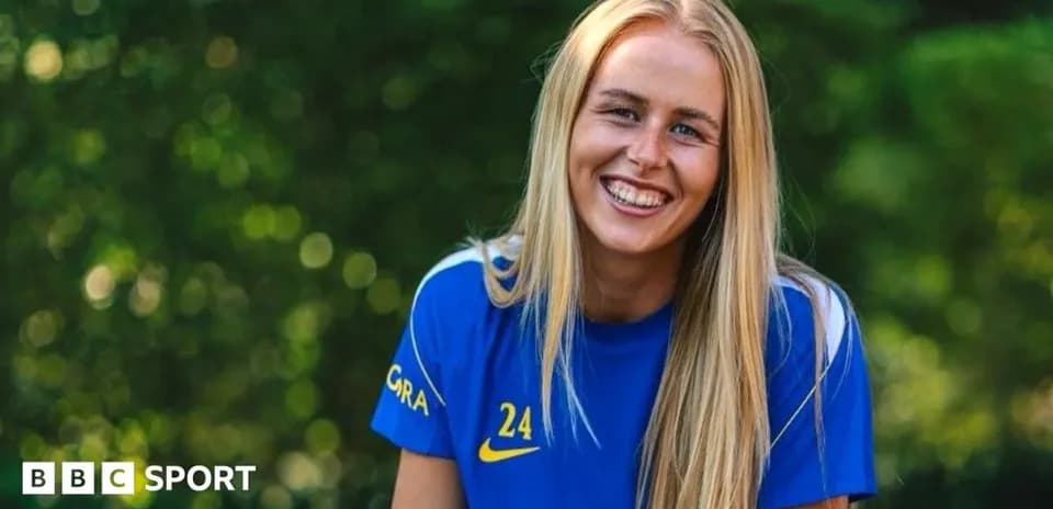 Player smiling while wearing blue team jersey