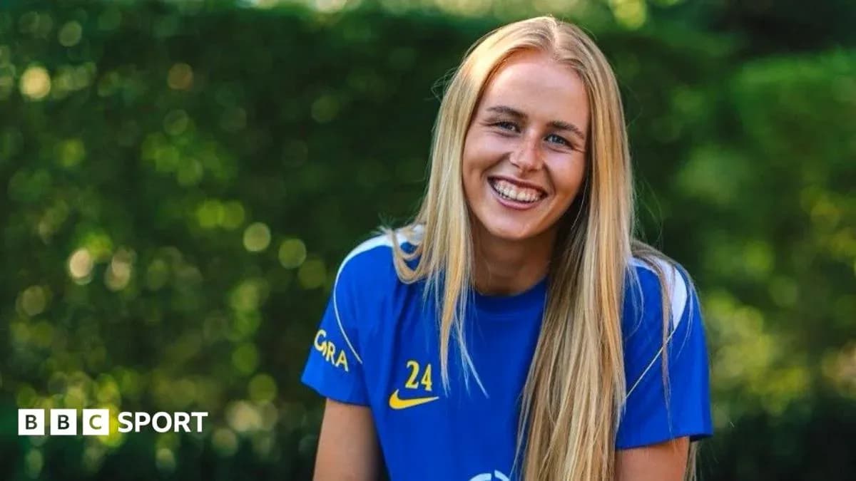 Player smiling while wearing blue team jersey