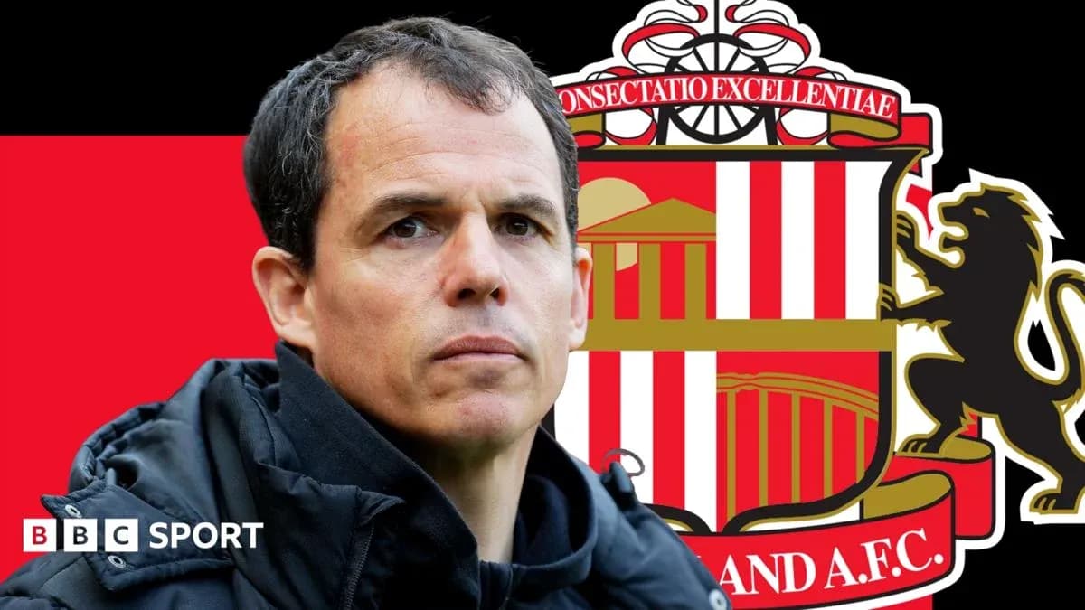 Coach in front of Sunderland AFC logo backdrop