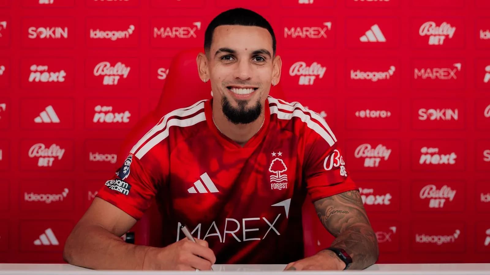 Player signing contract at Nottingham Forest press conference