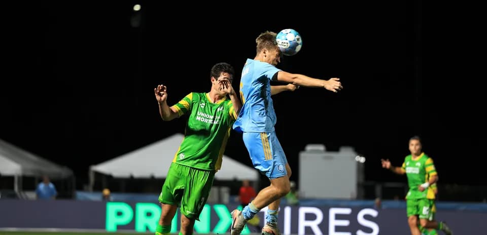 Player heads the ball during JAX vs Tampa Bay match
