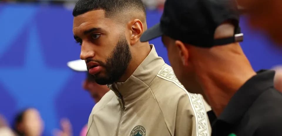Player wearing Morocco team jacket in conversation