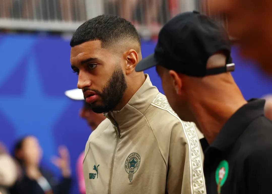 Player wearing Morocco team jacket in conversation