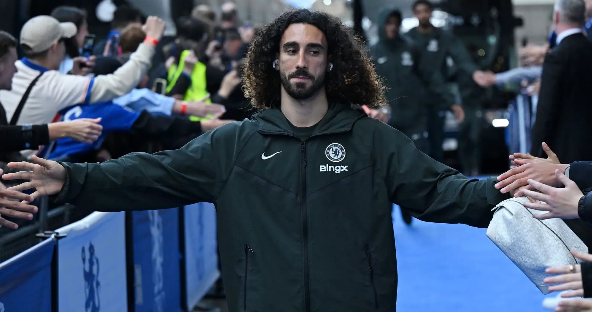 Player greeting fans while entering the stadium