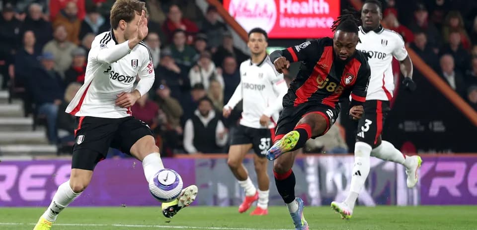 Fulham player challenges Bournemouth opponent during match