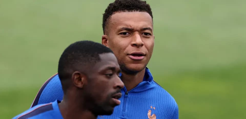 Two players training together in blue jerseys