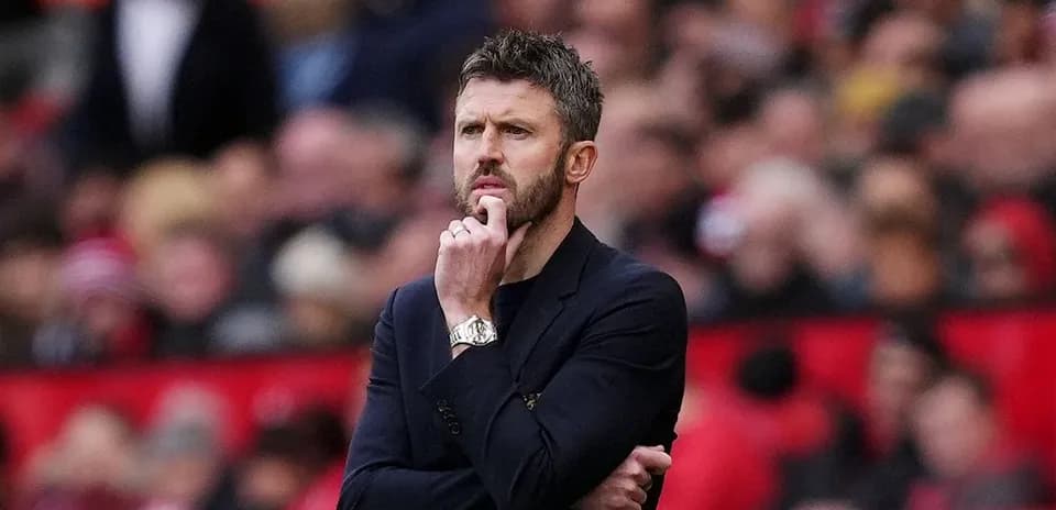Coach observing the match with a thoughtful expression