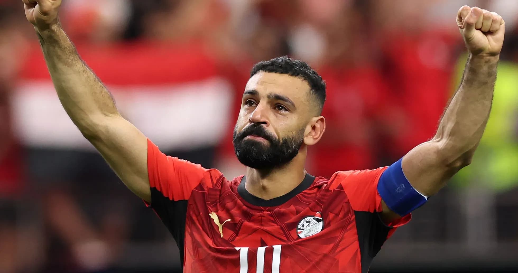 Player celebrating with raised fist in Egypt jersey