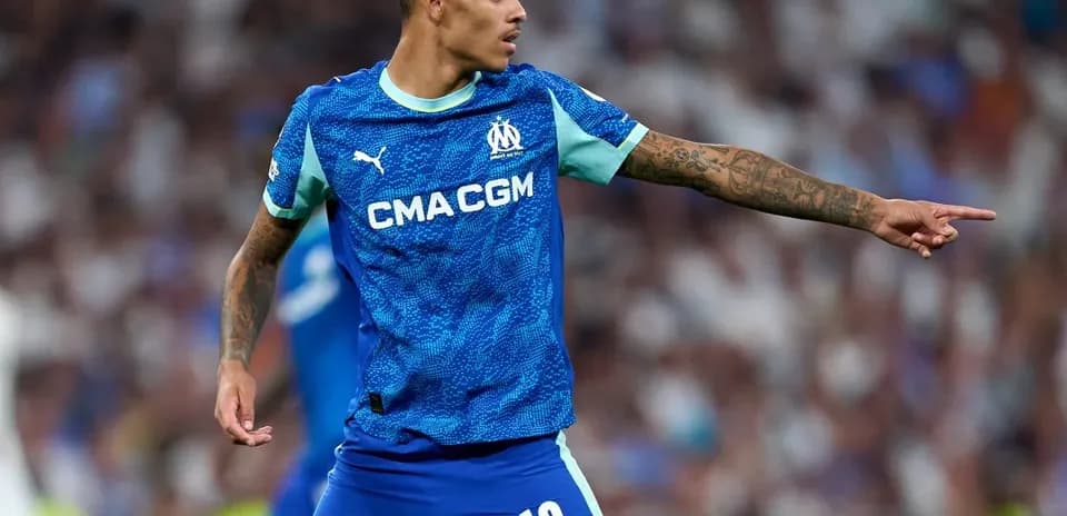 Player gesturing during match in blue jersey