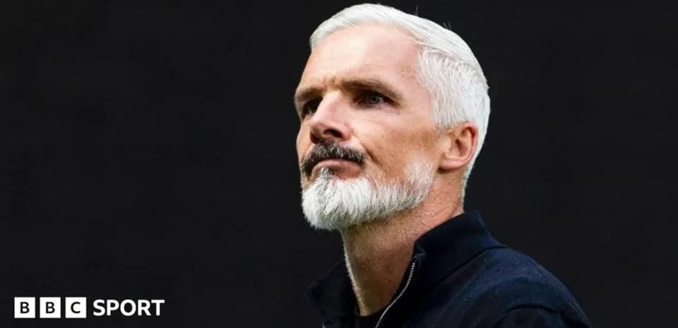 Coach with white hair and beard during event