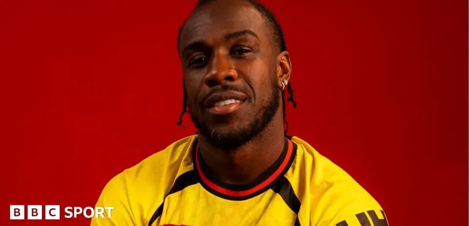 Player wearing Watford jersey against red background