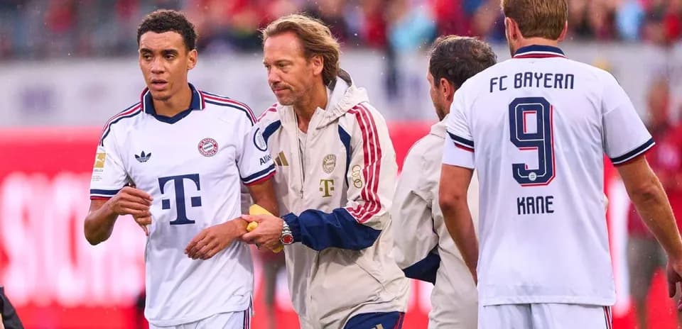 Bayern Munich players and staff during match substitution
