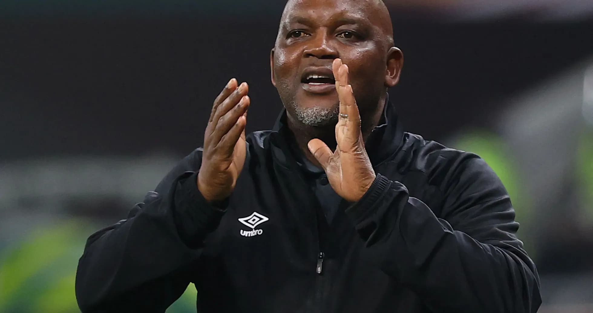 Coach gesturing during a match from the sideline