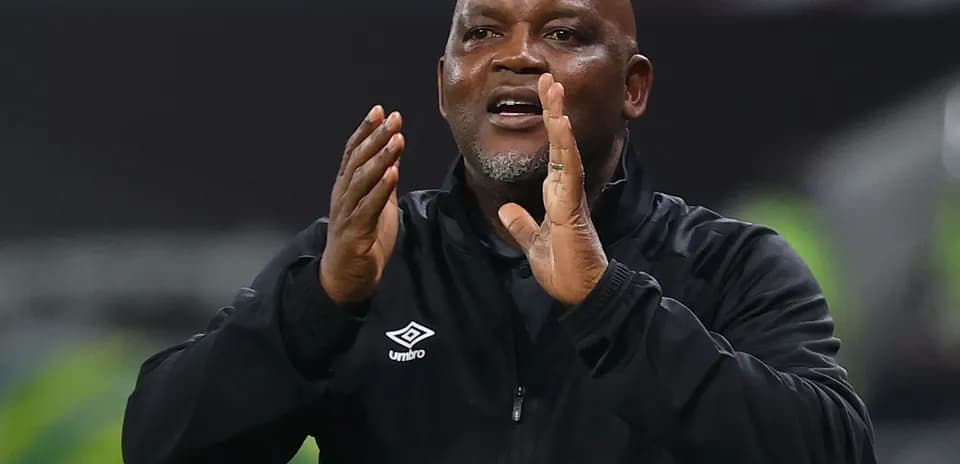Coach gesturing during a match from the sideline