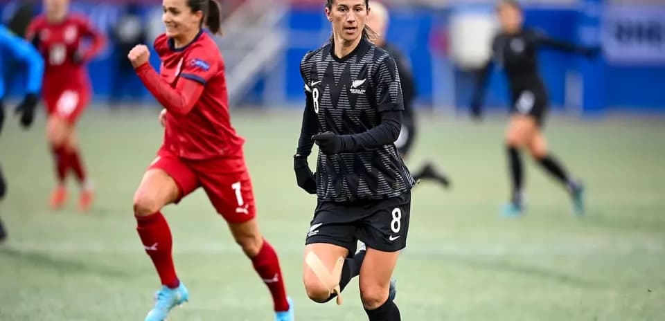 Player in black jersey running on field during match