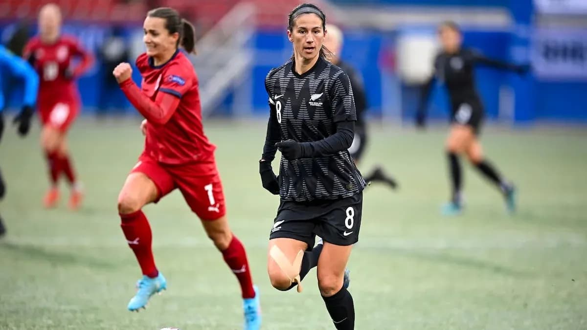 Player in black jersey running on field during match