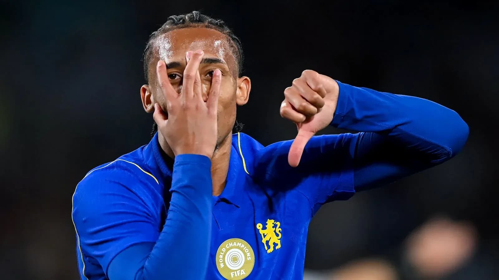 Player gesturing during match celebration in blue jersey