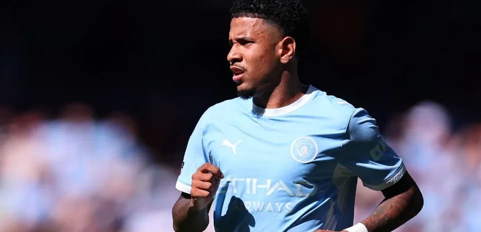 Player running on the pitch in Manchester City kit