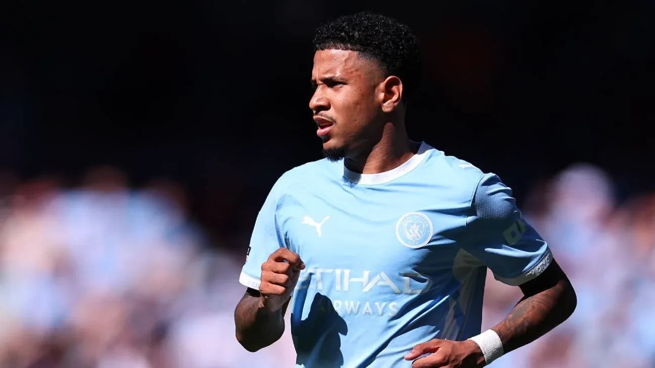 Player running on the pitch in Manchester City kit