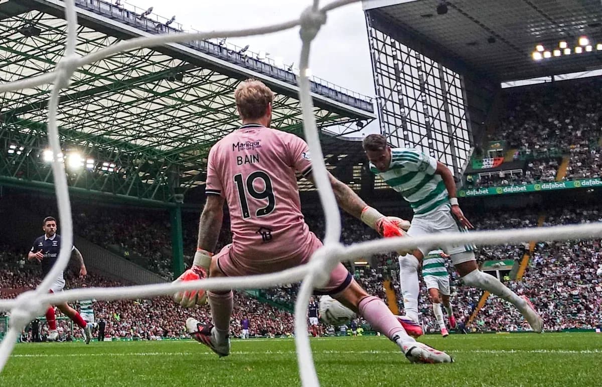 Celtic player attempting to score past goalkeeper Bain