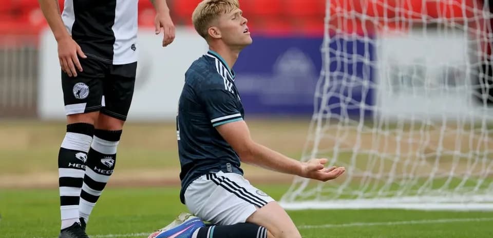 Player kneeling on pitch during match action