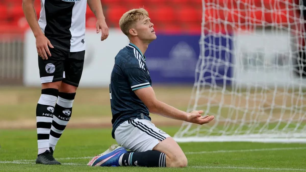 Player kneeling on pitch during match action