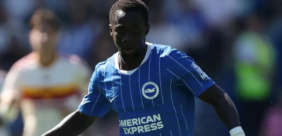 Player in blue jersey dribbling the ball on field