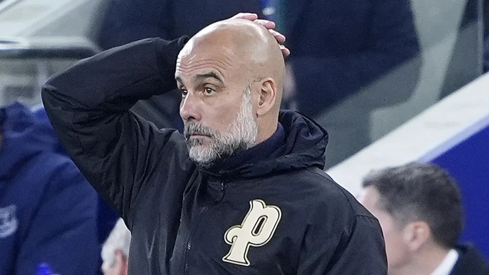 Coach observing the game with hand on head