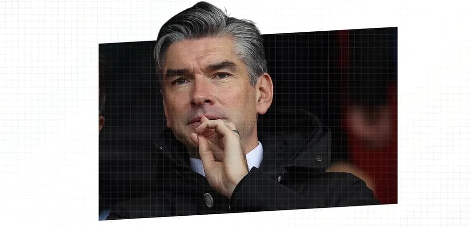 Man in suit observing from the stands