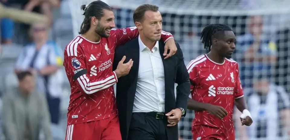 Liverpool players celebrating with the manager after match
