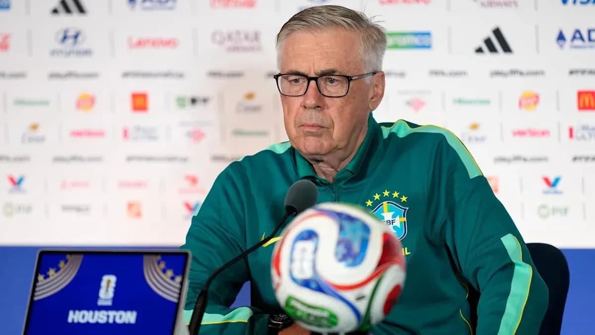 Coach at press conference with soccer ball and laptop